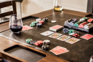 Poker Table Setup with Cards, Chips, and Wine Glasses