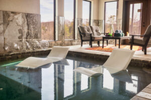 Indoor Pool with Loungers and Access to Private Patio