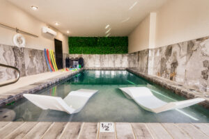 Indoor Heated Pool with Lounge Beds and Poolside Games