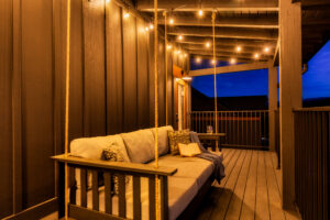 String-Lit Porch with Swing Bed & Cushions
